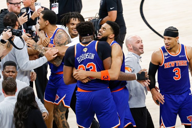 Karl-Anthony Towns #32 and Mitchell Robinson #23 of the New York Knicks celebrate after the victory against the San Antonio Spurs in Game Five of the 2026 NBA Finals.
