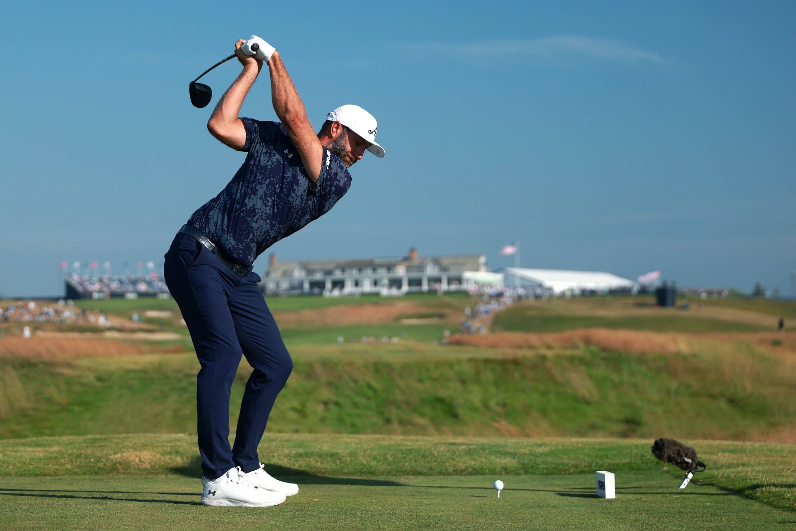 Dustin Johnson, who started on the back nine, plays a shot from the 18th tee.