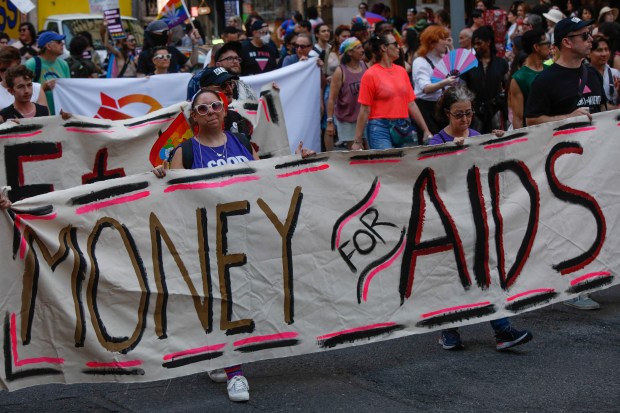People hold a banner reading "Money for AIDS" as they take part in the Queer Liberation March in New York on June 28, 2026. (Photo by kena betancur / AFP via Getty Images)
