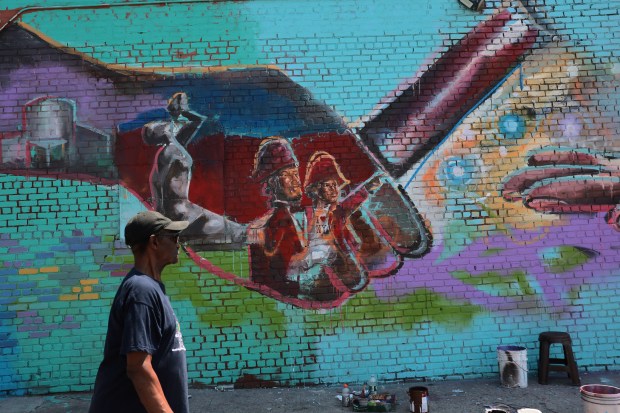 NEW YORK, NEW YORK - JUNE 25: A person walks past a Toussaint Louverture mural on June 25, 2026 in the Little Haiti neighborhood of the Brooklyn borough in New York City. In a 6-3 ruling, the Supreme Court ruled in favor of the Trump administration's effort to strip temporary protected status (TPS) from hundreds of thousands of Haitians and Syrians, who were legally in the U.S. and protected from deportation, including many who have lived legally in the country for years. (Photo by Michael M. Santiago/Getty Images)