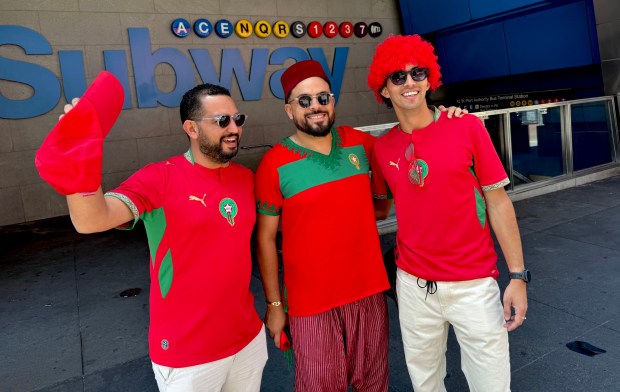 Morocco fans Amine Mobtahij, 31 (far right) and friends wait for buses to the World Cup game in New Jersey on Saturday.