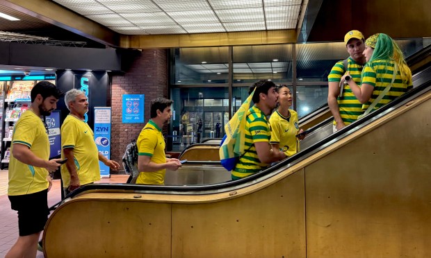Fans arrive at Port Authority Bus Terminal in Manhattan to catch official shuttle buses to the World Cup game in New Jersey on Saturday afternoon.