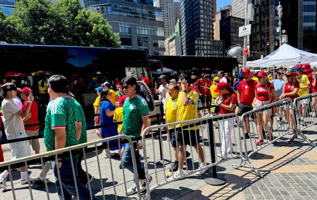 Fans line up to enter Columbus Circle shuttle buses to a World Cup game in New Jersey on Saturday.