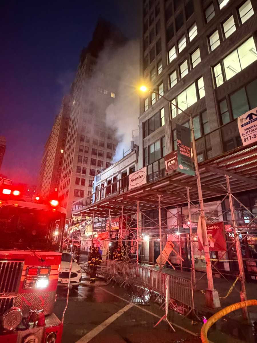 firefighters work on three-alarm fire in Midtown building