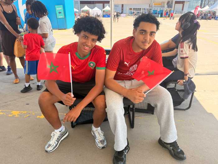 Yahya (left) and his brother Adam (right) got to the FIFA Bronx Fan Zone early, but were waiting to catch their native country Morocco take on Brazil later that night.