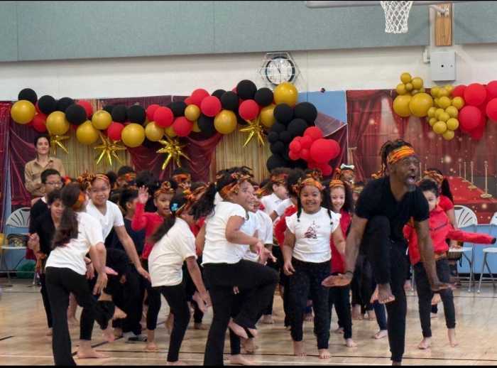 children dancing in a gymnasium