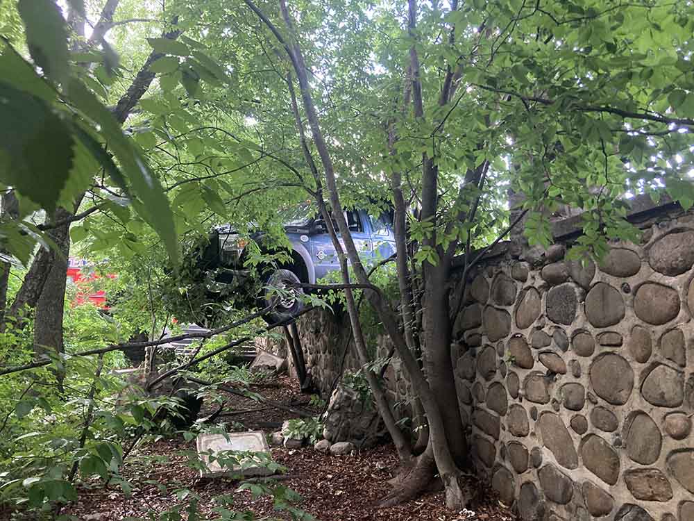 Bedford Park: One Arrested, One Injured in Crash as Truck Hangs Over Mosholu Parkway Wall