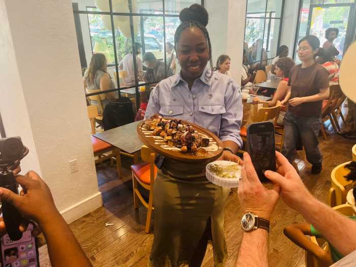 Serving food at the grand opening of Sweet Sundays Café & Eatery's second location.