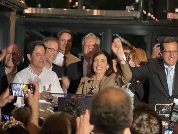 Gov. Kathy Hochul, center, congratulates Micah Lasher, far right, at his primary election night party at Jacob's Pickles on the Upper West Side of Manhattan on Tuesday, June 23, 2026. (Cayla Bamberger / New York Daily News)