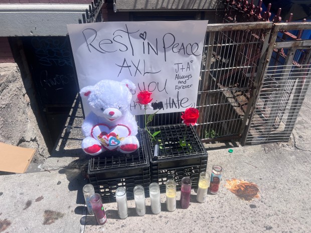 A memorial for Axl Ortiz, who was fatally shot on E. 187th St. near Park Ave. in the Bronx on Monday, June 23, is pictured outside the building where he had been living for less than a week with his girlfriend and her son. (Emma Seiwell / New York Daily News)
