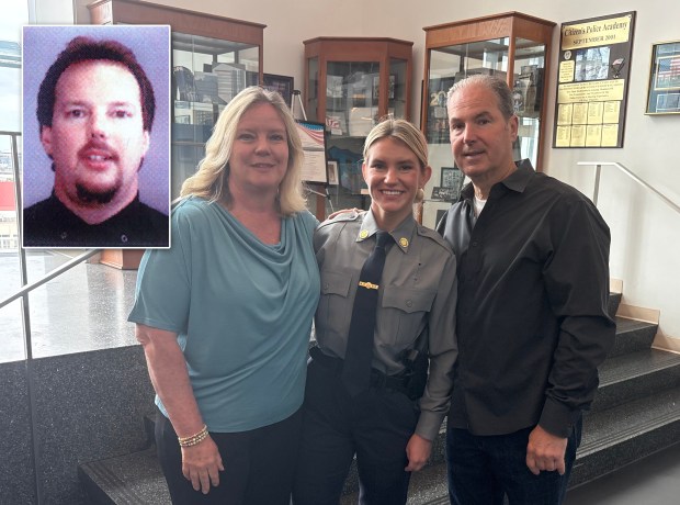 NYPD graduate Erica Tierney, center, is pictured with her parents on Tuesday, June 23, 2026, in Queens, New York. Tierney's uncle, NYPD Officer Stephen Driscoll, died on 9/11. (Roni Jacobson / New York Daily News; NYPD)