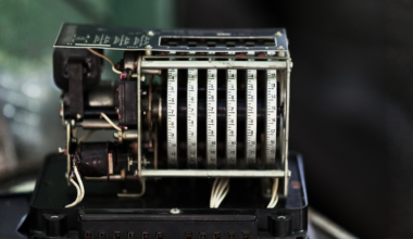 In 1944, an IBM machine called the Harvard Mark I clattered through a calculation for the Manhattan Project at three additions per second, fed by paper tape and operated by a young Navy lieutenant named Grace Hopper who took the graveyard shift more often than anyone and slept beside it on a cot, waking the moment the relays went quiet because a silent machine meant something had gone wrong