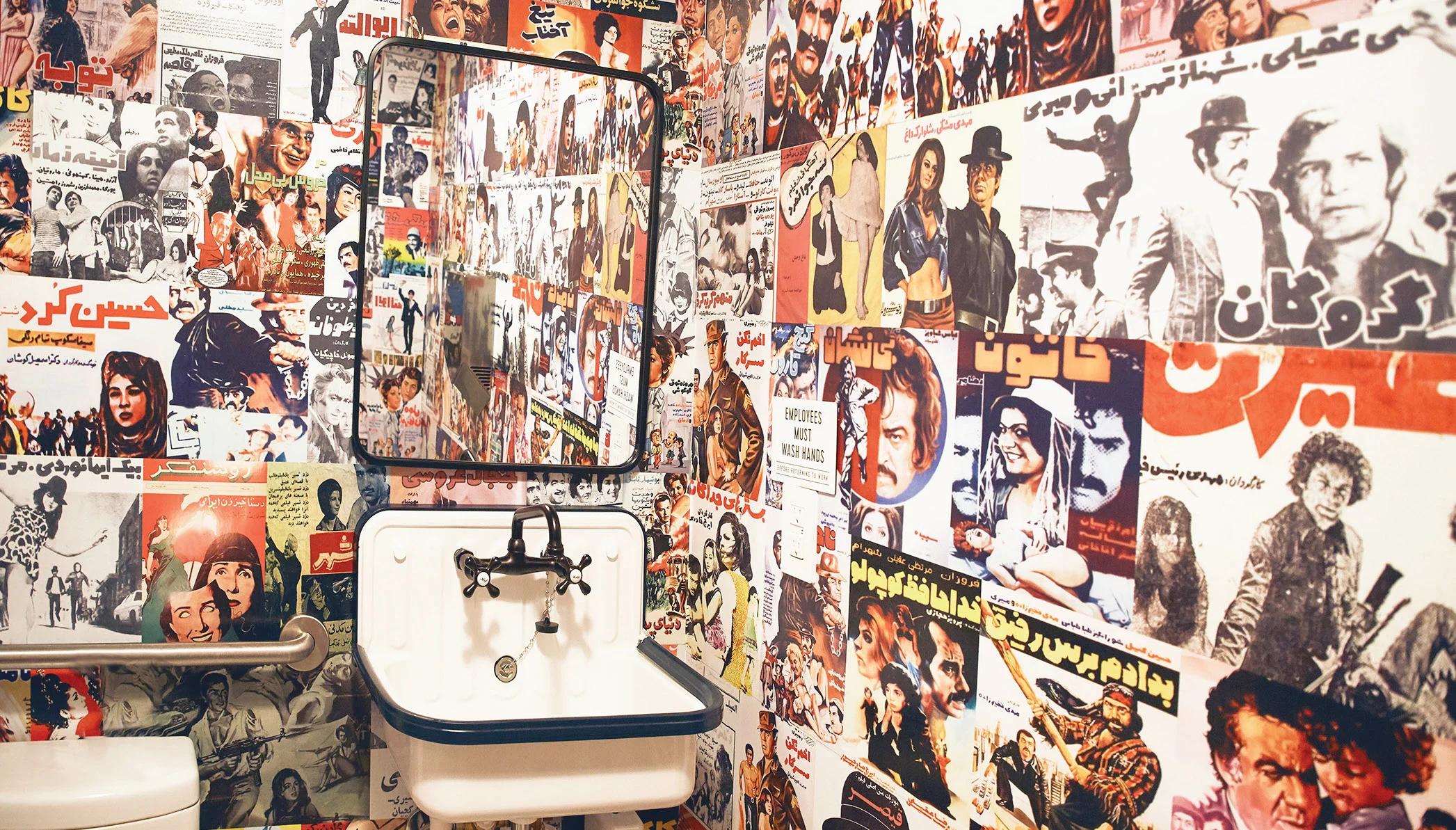 A bathroom wallpapered with Iraqi magazine pages.