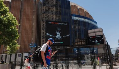 People walked near a security fence around Madison Square Garden ahead of Game 3 of the NBA Finals between New York Knicks and San Antonio Spurs on Monday. The New York City Police Department and Secret Service have cancelled a NBA Finals watch party near Madison Square Garden, with fans advised to arrive at least two hours before Monday's game due to heightened security for President Trump's attendance.
