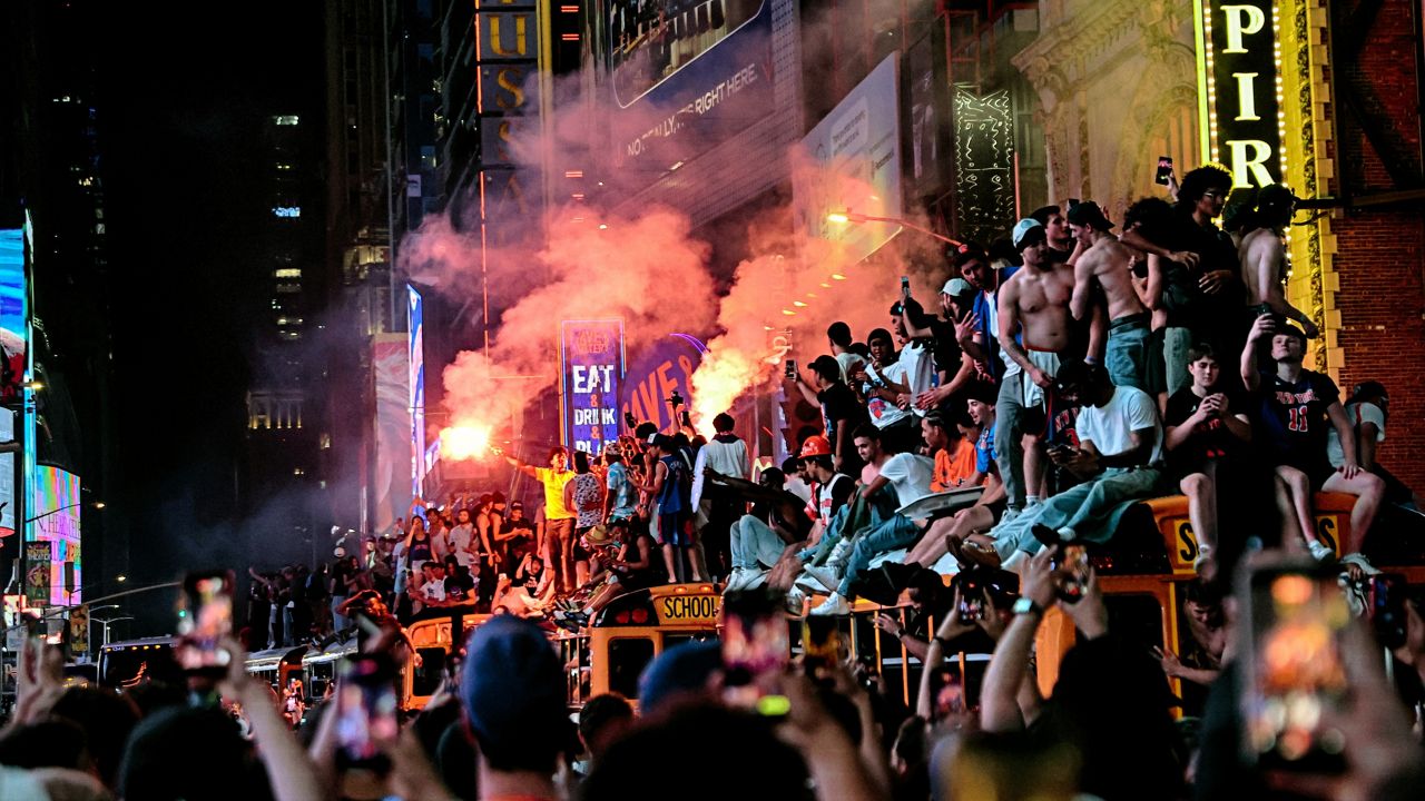 New York Knicks fans celebrate their victory after Game 5 of the NBA Finals basketball series against the San Antonio Spurs, Saturday, June 13, 2026, in New York. (AP Photo/Heather Khalifa)