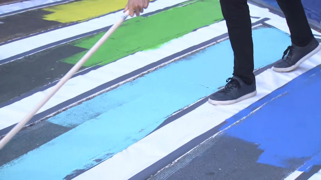 Before the first marcher steps off, there's already debate over who should be in the parade. (Spectrum News NY1)