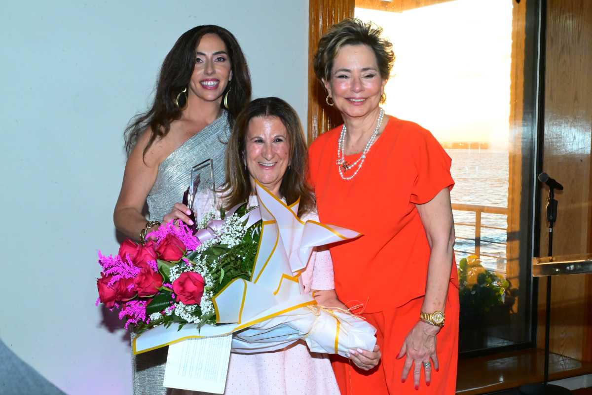 Meryl Schwartz (c.) accepts an award from Brooklyn Women's Bar Association President Lisa Michael.