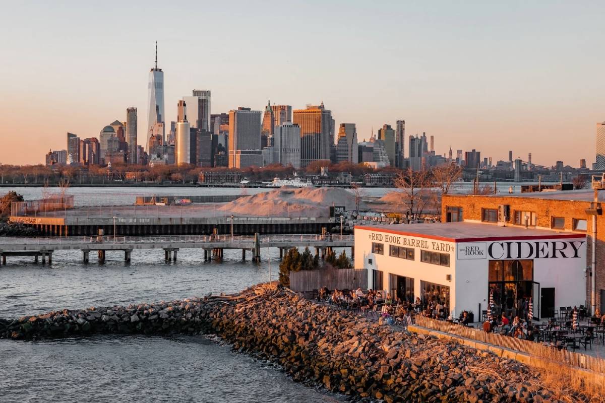 This hidden 3-in-1 waterfront barrel yard is tucked into Brooklyn’s most remote neighborhood—featuring a winery, distillery, cidery, and 180° Manhattan skyline views