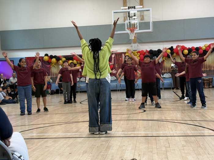 students dancing in a school gymnasium