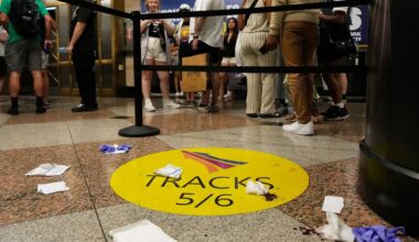 People stand near an area roped off after a stabbing at Penn Station on Sunday, June 7, 2026. (AP Photo/Ross D. Franklin)
