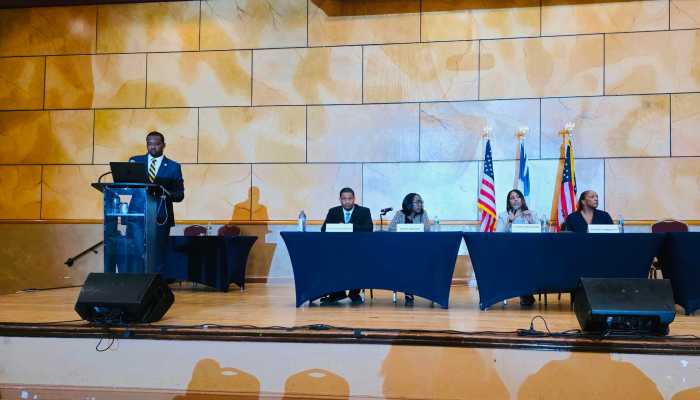 District 32 Assembly candidates sit during the candidate forum as they answer questions from the audience. The forum was moderated by NAACP New York State Conference Executive Director Chris Alexander, who is also seen in the photo. The forum was held on Saturday, May 16, 2026, at the Rochdale Village Grand Ballroom, 165-69 137th Avenue, Jamaica, Queens, NY. 