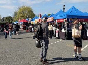 people walking around among festival tents