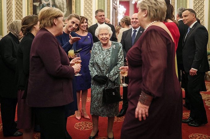 Britain's Queen Elizabeth II (C) speaks with guests in Buckingham Palace in central London on at Britain Nato Summit Defence Diplomacy