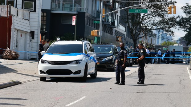 Police are pictured at Queens Blvd. and 70th St. in Woodside after an officer was shot on August 30, 2023.