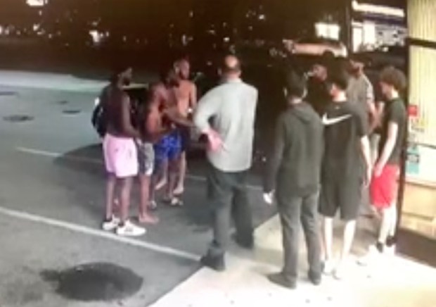 O'Shae Sibley, left, wearing pink shorts, and Dmitriy Popov, right, wearing red shorts, are seen in video from the scene. (Obtained by Daily News)