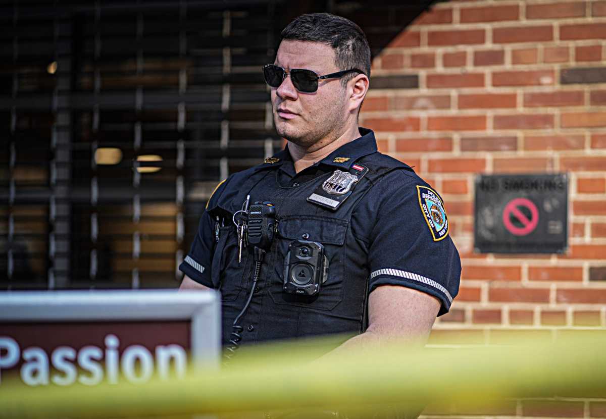 police officer in brooklyn staring at crime scene
