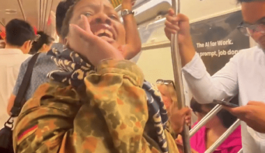 Woman aboard a Manhattan subway train during an antisemitic incident targeting an Orthodox Jewish passenger.