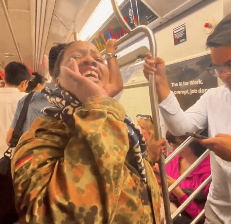 Woman aboard a Manhattan subway train during an antisemitic incident targeting an Orthodox Jewish passenger.