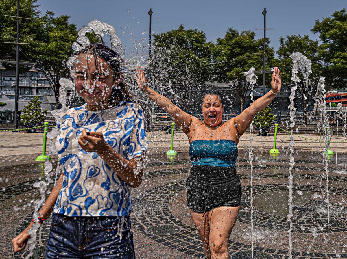people playing in fountain during nyc summer heat wave