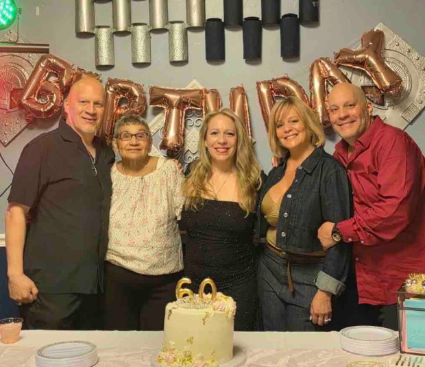 Diana Rolon (center) is pictured with her family on her 60th birthday. (GoFundMe)