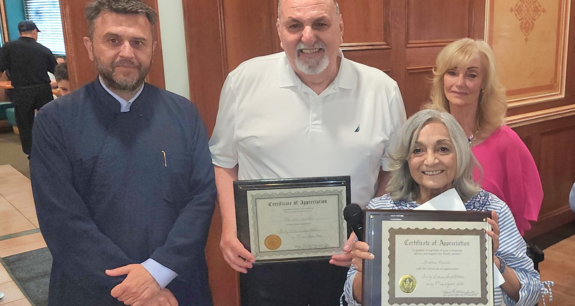 Pete Christofilakes and Christina Charitis were honored with commemorative plaques for their many years of contributions to the efforts of the Philoptochos. Next to them are Fr. Vasileios Apostolidis and Philoptochos President Dee Sidiropoulos. Photo: TNH/Michael Kakias