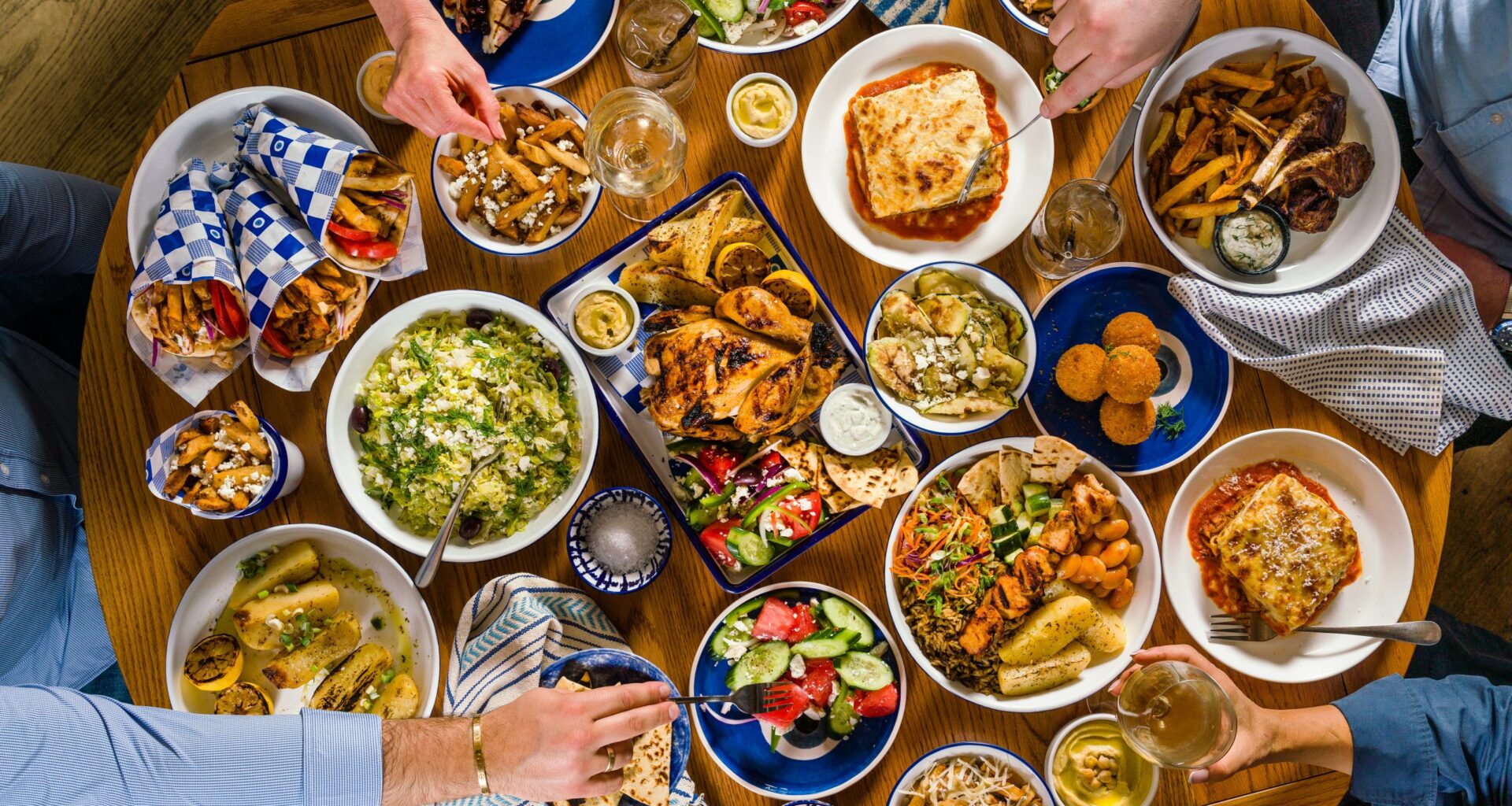 A table full of delicious Greek food from The Gyro Project. (Photo: Courtesy of The Gyro Project)