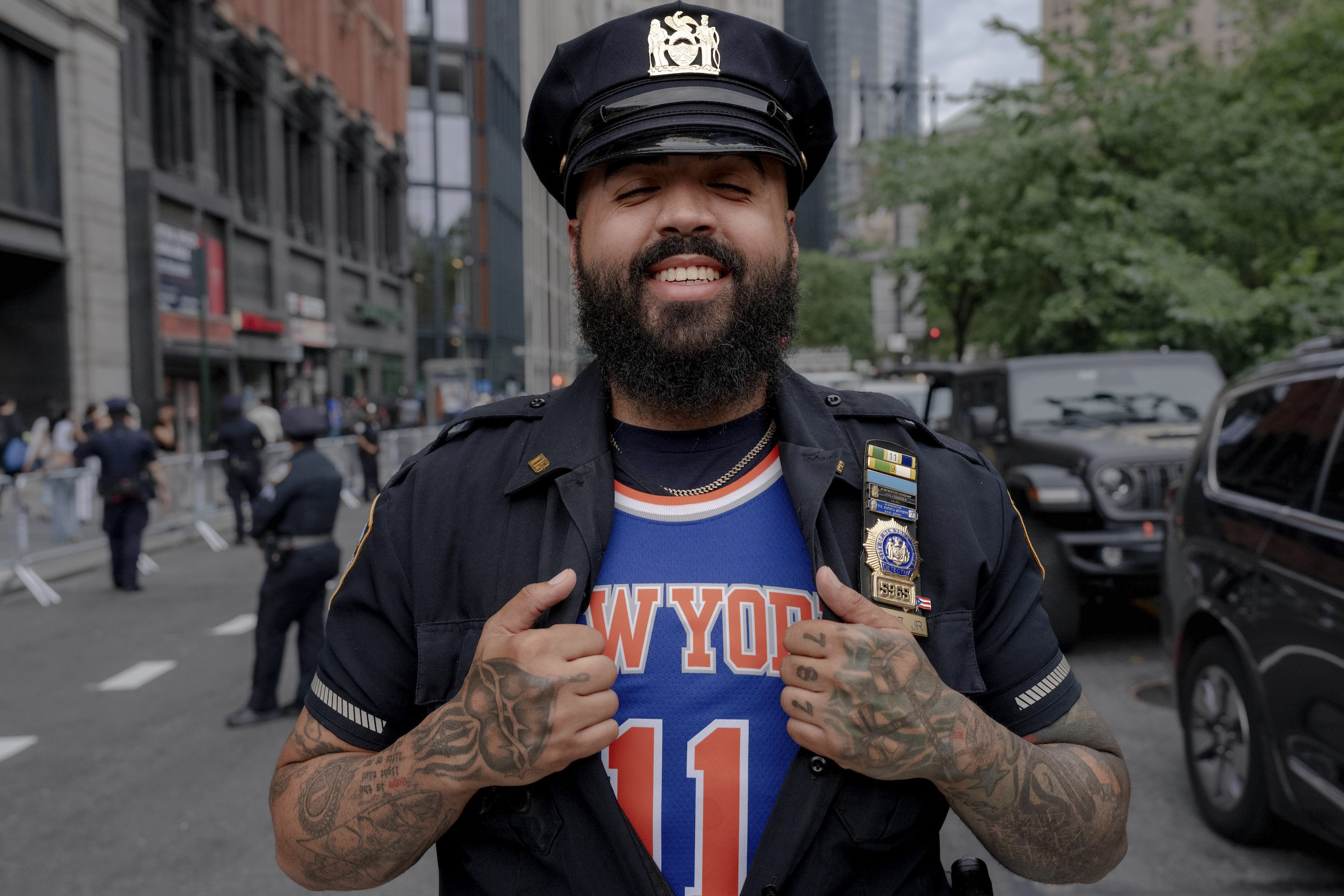 A New York Police Department officer shows his New York...