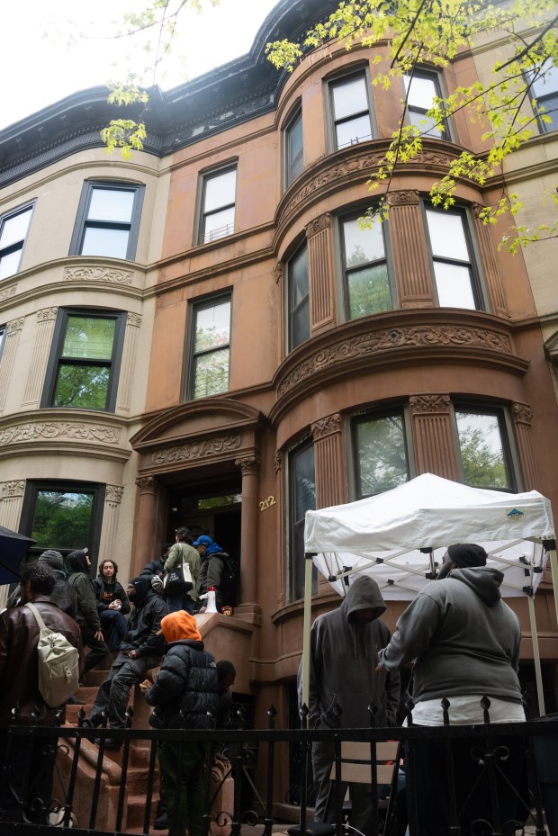 Protesters gather outside the home of Carmella Charrington at 212 Jefferson Ave. in Brooklyn, New York, on Wednesday, April 22, 2026. (Gardiner Anderson / New York Daily News)