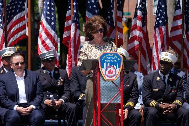 Mary Fahey, widow of Firefighter Brian Fahey, speaks at a a ceremony commemorating the 25th anniversary of the 2001 Father's Day fire on Astoria Blvd. and 14th St. in Queens, New York on Wednesday, June 17, 2026. (Gardiner Anderson / New York Daily News)
