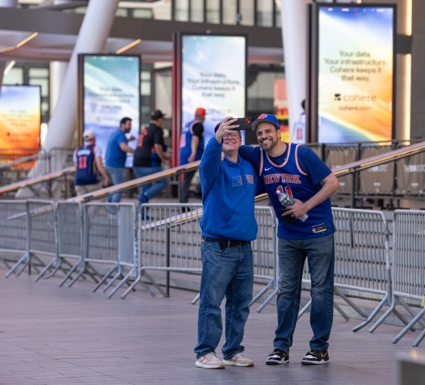 Knicks fans pose for a photo after being screened by the NYPD on W. 33rd St. outside Madison Square Garden Monday, June 8, 2026 in Manhattan, New York. (Barry Williams/ New York Daily News)