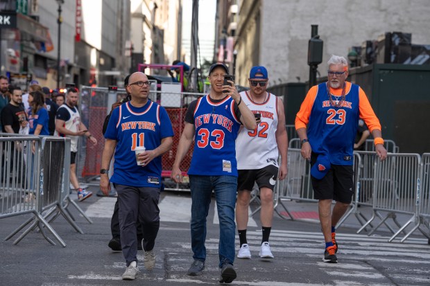 Knicks fans pose for a photo after being screened by the NYPD on W. 33rd St. outside Madison Square Garden Monday, June 8, 2026 in Manhattan, New York. (Barry Williams/ New York Daily News)