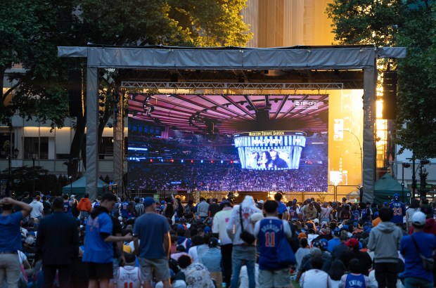 Knicks fans watch the pre-game show during a watch party iN Bryant Park for Game 3 on Monday.