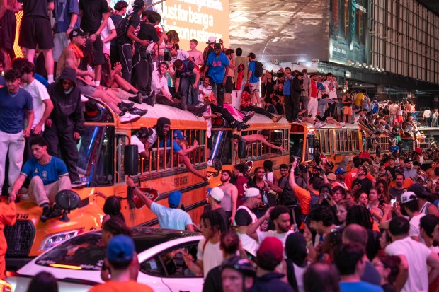 Knicks fans climb on buses on W. 42nd St. in Manhattan after the Knicks defeated the Spurs Saturday, June 13, 2026 in New York City. (Barry Williams/ New York Daily News)