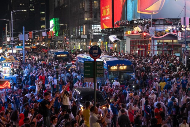 New York Knicks fans celebrate in Times Square after the Knicks defeated the San Antonio Spurs in the NBA Finals on Saturday, June 13, 2026 in Manhattan, New York. (Barry Williams/ New York Daily News)