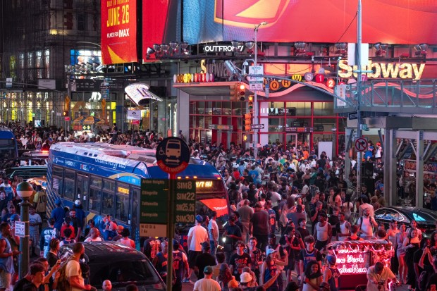 New York Knicks fans celebrate in Times Square after the Knicks defeated the San Antonio Spurs in the NBA Finals on Saturday, June 13, 2026 in Manhattan, New York. (Barry Williams/ New York Daily News)
