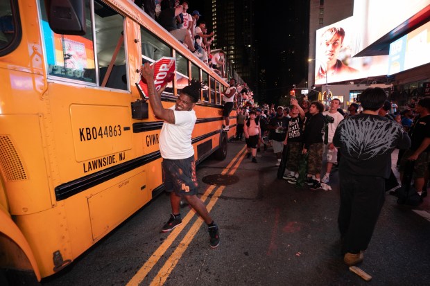 A man rips a stop sign off of a school bus on W. 42nd St. in Manhattan after the Knicks defeated the Spurs Saturday, June 13, 2026 in New York City. (Barry Williams/ New York Daily News)