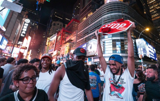 A Knicks fan shows off his trophy from a bus on w42nd St. after the Knicks defeated the Spurs Saturday, June 13, 2026 in Manhattan, New York. (Barry Williams/ New York Daily News)