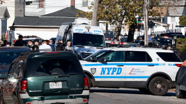 NYPD officers and detectives investigate a triple-murder on Milburn St. near 122nd Ave. in Queens on Tuesday, Nov. 14, 2023. (Luiz C. Ribeiro for New York Daily News)
