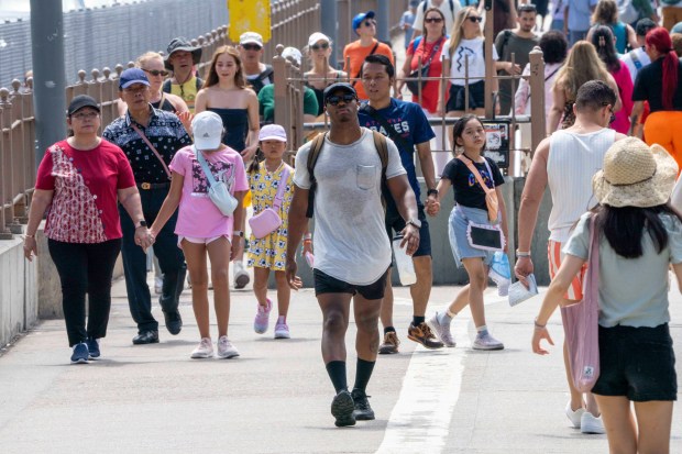 People cross the Brooklyn Bridge on a hot day in New York City on Thursday, June 20, 2024. (Theodore Parisienne for New York Daily News)