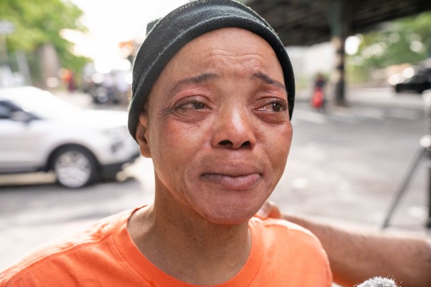 Angelique Irving Rutherford, who says she is the wife of 53-year-old victim, is pictured the morning after two men were fatally shot on Westchester Ave. near Harrod Ave. in the Bronx. (Theodore Parisienne / New York Daily News)